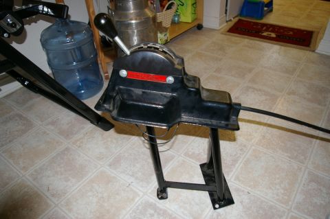 1986 Ford Bronco - Shifter assembly on a stand, with a red label visible on the unit.
