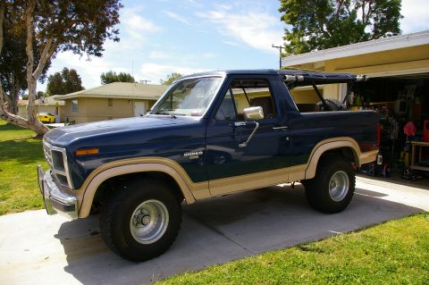 1986 Ford Bronco - This 1986 Ford Bronco is parked in a driveway with a garage in the background.