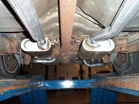 1991 Ford Crown Victoria - The undercarriage of a vehicle is shown, with the exhaust system and rear differential visible.