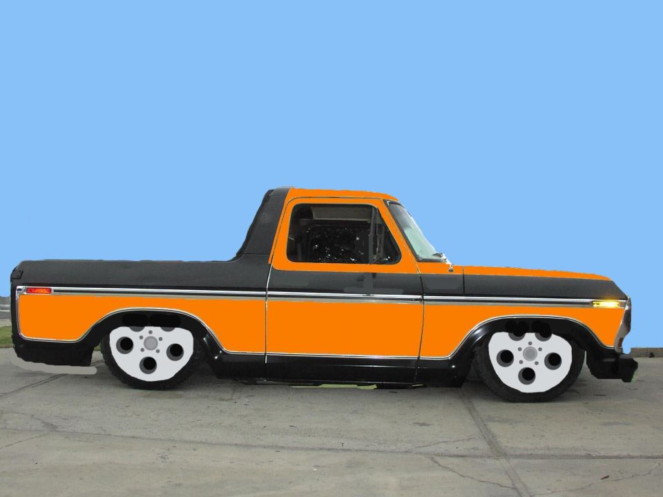 Orange and black customized pickup truck with custom wheels, lowered suspension