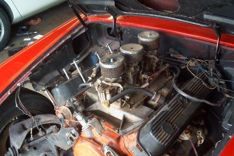 1972 Ford Ranchero - Close-up view of a V8 engine a triple carburetor setup with air filters.