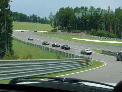 1993 Ford Mustang - Police cars on a race track during an event.
