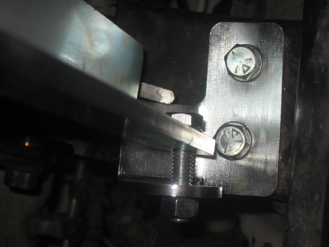 Metal bracket bolted to frame with visible Supermotors.net watermark