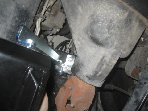 2000 Jeep TJ - Custom bracket attached to exhaust pipe, likely for aftermarket modification.
