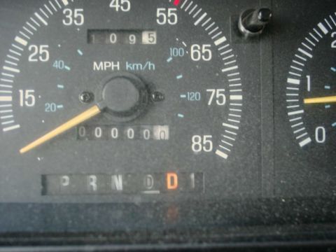 1988 Ford Bronco - The odometer reads 1095 miles, and the gear selector is in Drive.
