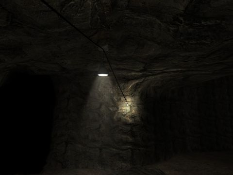 1969 Ford Mustang - A light hangs from a wire, casting a beam onto the textured walls of a dark cave.