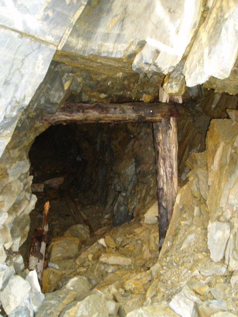 2000 Ford E350 - Interior of a mine shaft, showing wooden supports and rocky terrain.