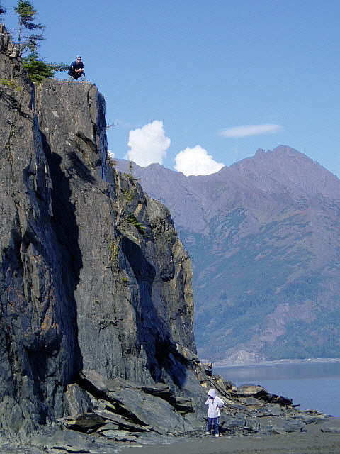 2000 Ford E350 - A scenic view of a rocky coastline with two people observing the landscape.