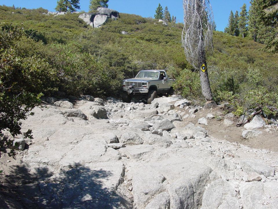 Silver pickup truck on a rocky, off-road trail