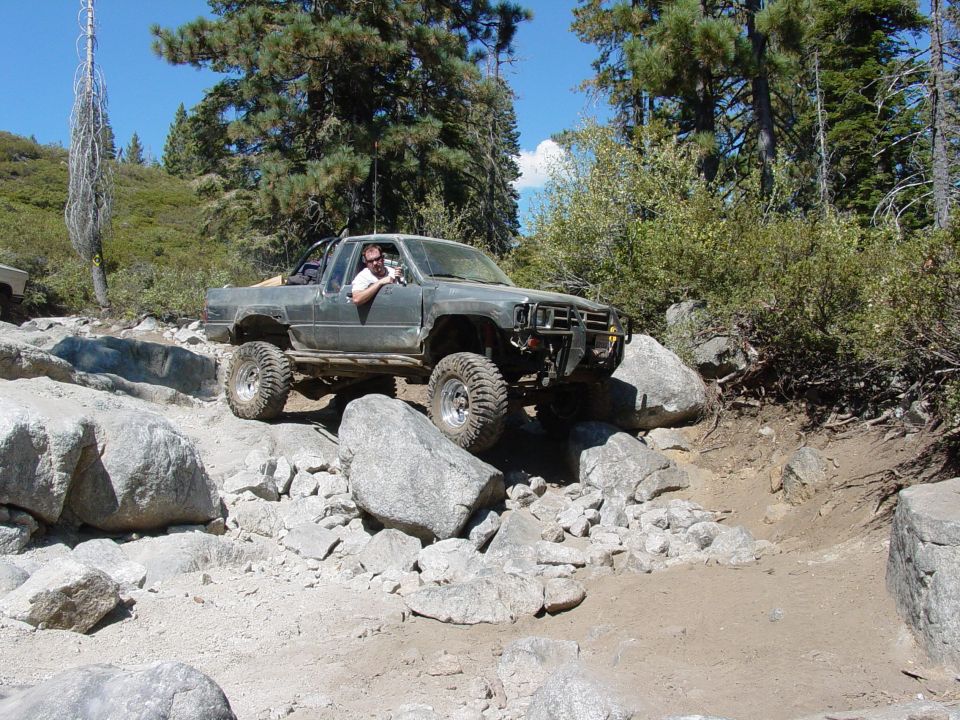 Gray off-road truck navigating rocky terrain