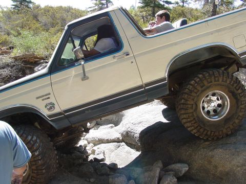 1986 Ford Bronco - This 1986 Ford Bronco navigates a rocky trail, demonstrating its off-road capabilities.