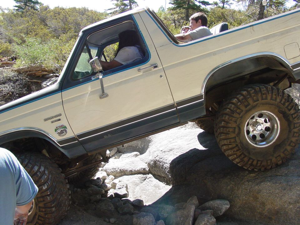 1986 Ford Bronco off-roading over rocks