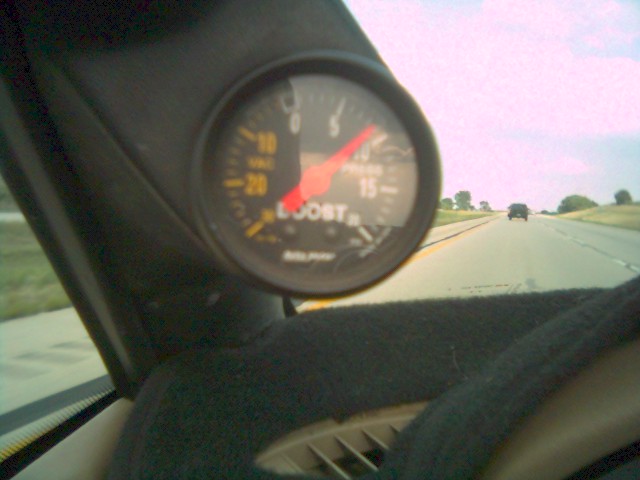 Auto Meter boost gauge in an A-pillar pod, seen from the driver's seat on the highway