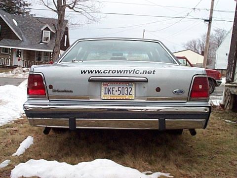 1991 Ford Crown Victoria - Rear view of a 1991 Ford Crown Victoria, showing its license plate and a website address on the trunk.