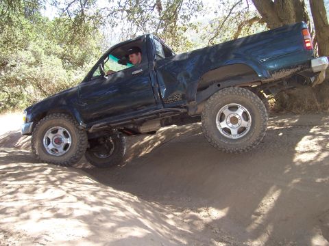 1995 Toyota Hilux - This 1995 Toyota Hilux is navigating a challenging dirt trail.