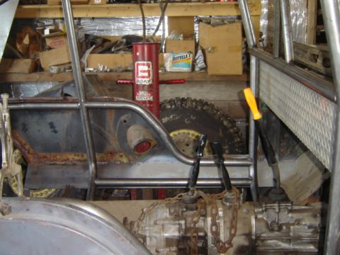 1992 Ford Bronco - Interior view of a heavily modified off-road vehicle, showing its transmission and roll cage structure.