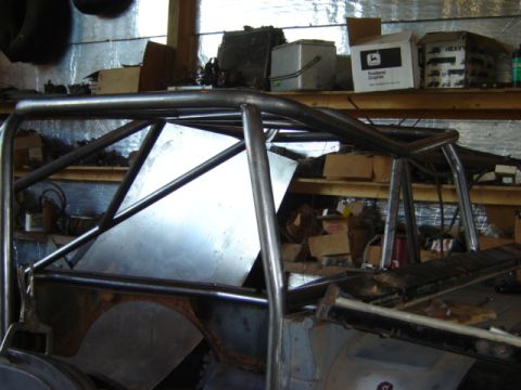 1992 Ford Bronco - Interior view of a vehicle undergoing modification with a custom roll cage installed.