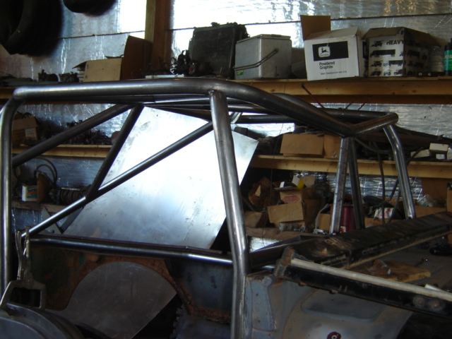Roll cage inside a vehicle, viewed from the interior. Metal tubing forms a protective structure