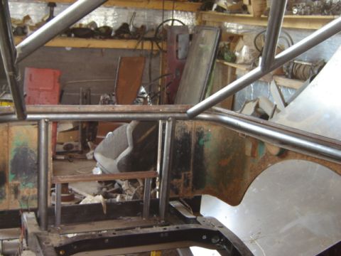 1992 Ford Bronco - Vehicle interior with roll cage installation in progress, workshop setting.