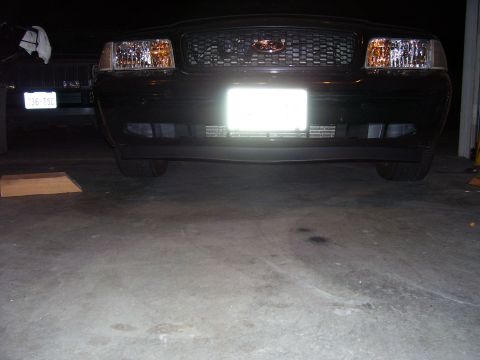 2002 Ford Crown Victoria - Front view of a 2002 Ford Crown Victoria, parked indoors with another car visible to the side.