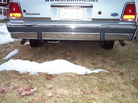 1991 Ford Crown Victoria - The rear view of a 1991 Ford Crown Victoria, showing its chrome bumper and distinctive taillights.