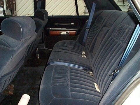1991 Ford Crown Victoria - The interior of a car shows the rear velour seats and door panel details.