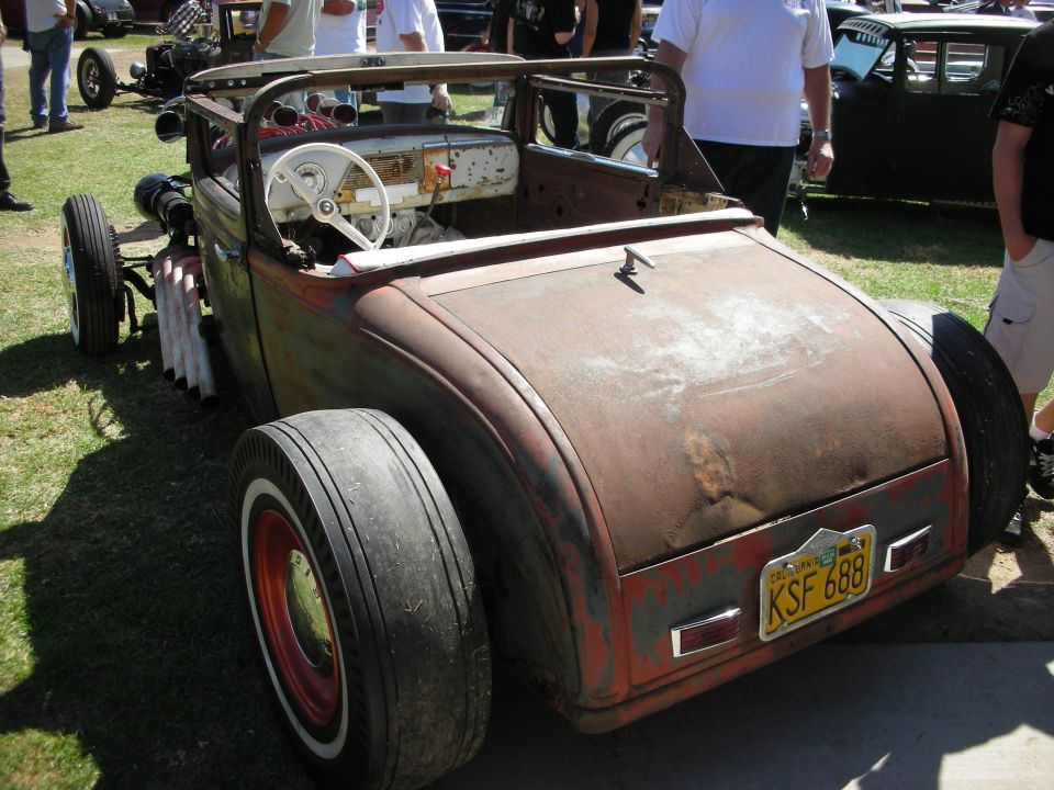 Rusty bare-metal rat rod roadster rear view with KSF 688 plate