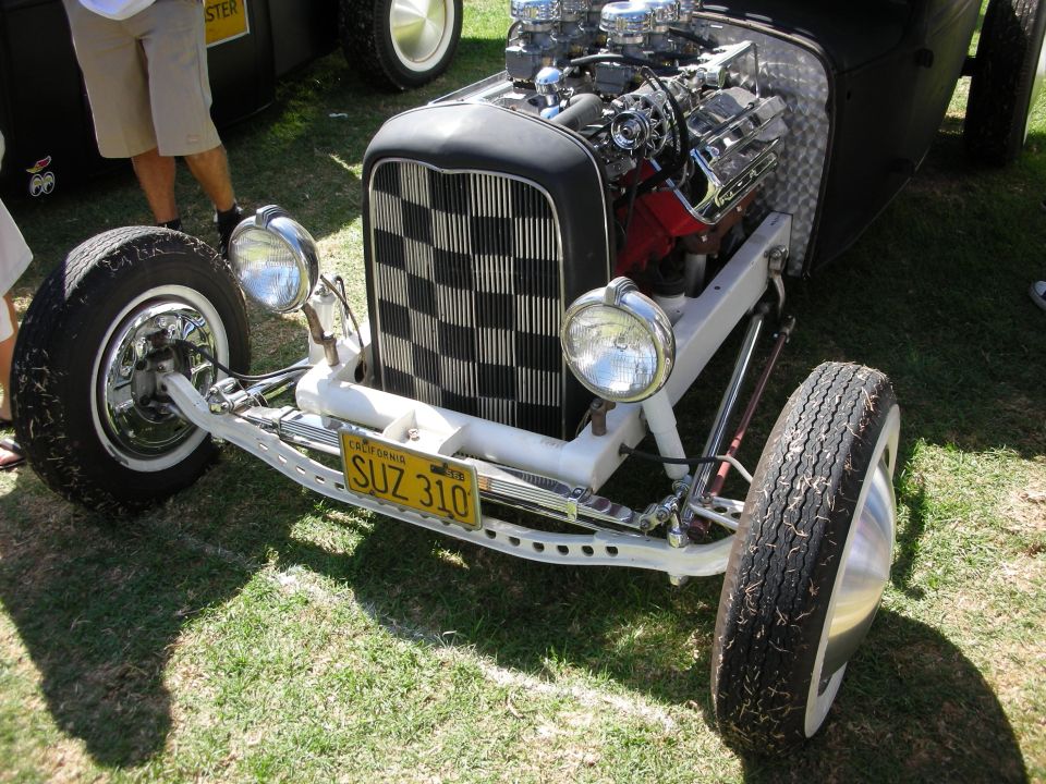 Black hot rod roadster with checkerboard grille and supercharged engine, plate SUZ 310