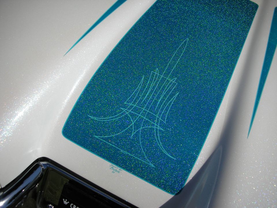 Teal metalflake scallop with hand-laid pinstriping on a white painted panel
