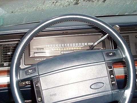 1991 Ford Crown Victoria - The interior of a 1991 Ford Crown Victoria is visible, with a focus on the dashboard and steering wheel.