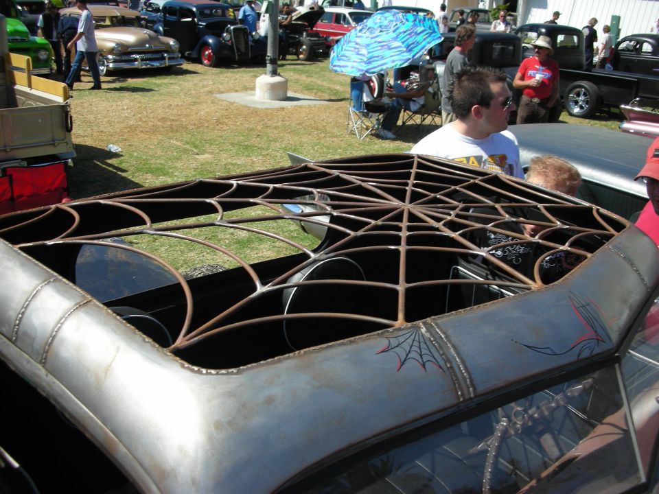 Custom car roof opening fabricated as a metal spider-web in bare steel