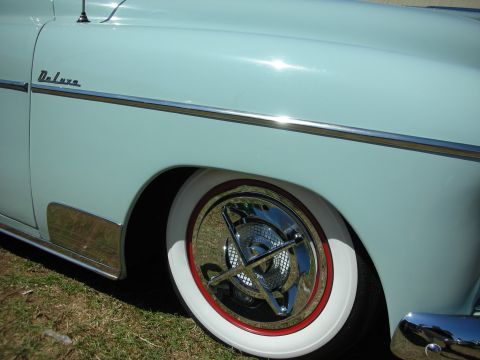 1998 Ford Crown Victoria - Lowered light-blue custom car fender with Deluxe script, wide whitewall tire and chrome wheel with a Masonic compass spinner.