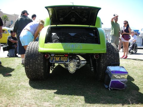 1998 Ford Crown Victoria - Rear view of a green metalflake custom car at a show, twin fans visible under the open decklid and a 'FINK ROD' California plate, with spec…