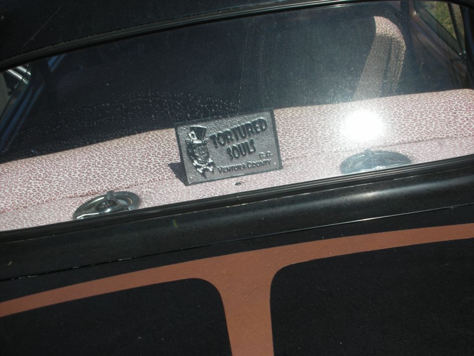 Tortured Souls Ventura County club plaque in the rear window of a custom car