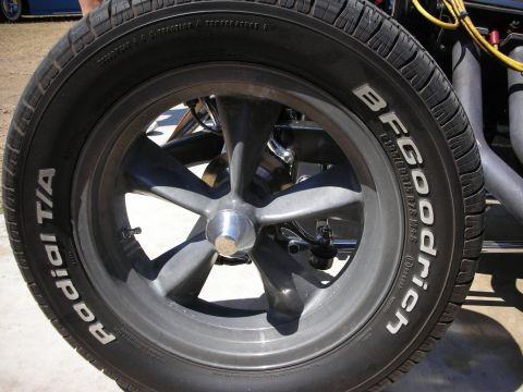1998 Ford Crown Victoria - Tight detail of a gray five-spoke mag wheel mounted with a BFGoodrich Radial T/A raised-white-letter tire on a hot rod.