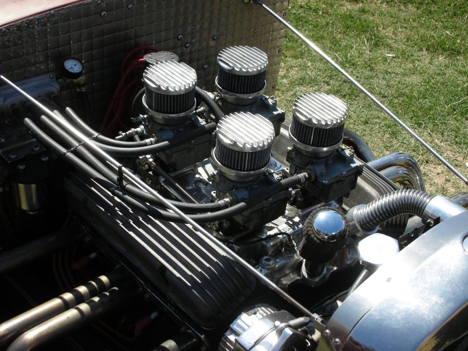 Overhead view of V8 engine with four finned chrome carburetor air cleaners