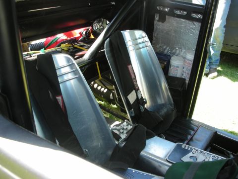 1998 Ford Crown Victoria - Bare custom car interior fitted with two polished aluminum racing bucket seats, harnesses and a roll bar.