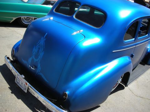 1998 Ford Crown Victoria - Rear three-quarter view of a glossy blue chopped 1930s coupe with subtle pinstriping and California plate EEE 2LOW.