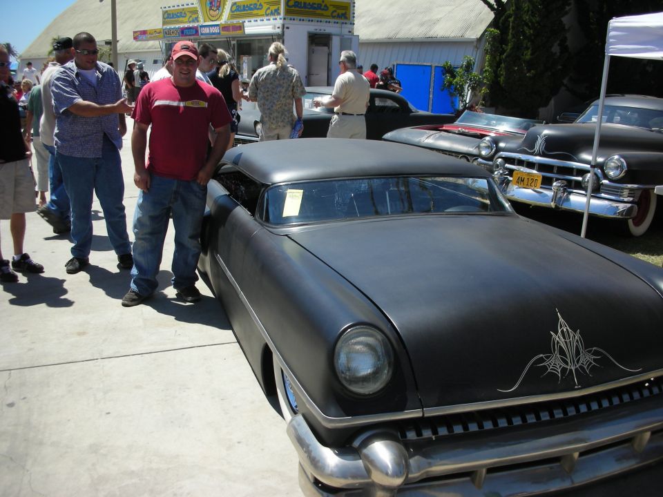 Flat-black chopped 1954 Mercury-style custom with pinstriping at a show