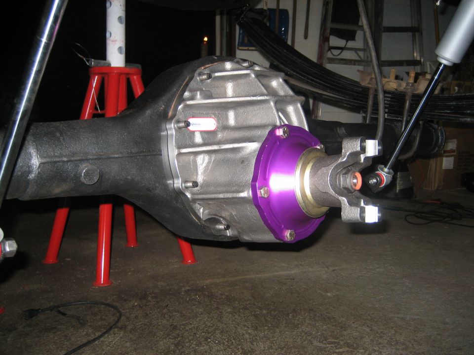 Rear axle differential with purple anodized pinion support and yoke under a truck
