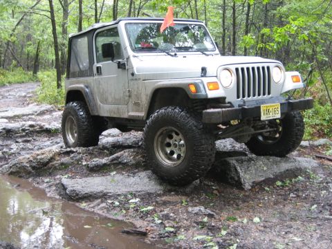 2002 Jeep Wrangler - Silver 2002 Jeep Wrangler navigating a challenging rocky off-road course.