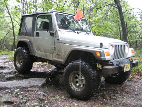 2002 Jeep Wrangler - This Jeep Wrangler navigates a challenging off-road course with large tires and a lifted suspension.