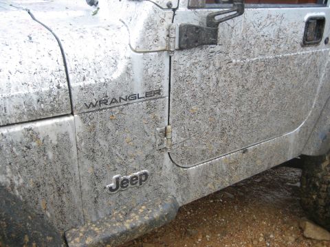 2002 Jeep Wrangler - This Jeep Wrangler is covered in mud, obscuring its exact model year.