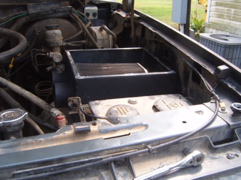 1988 Ford Bronco - The engine bay shows a custom air intake box and various engine components.