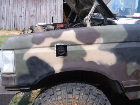 1988 Ford Bronco - This 1988 Ford Bronco features a camouflage paint job and a custom snorkel intake installed on the fender.