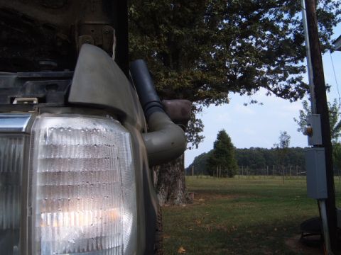 1988 Ford Bronco - Close-up of a 1988 Ford Bronco's snorkel installation, showing the headlight and fender area.