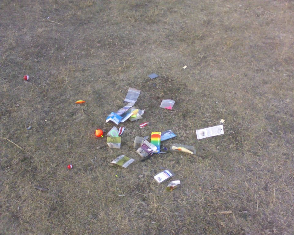 Scattered fishing lures and tackle on the ground