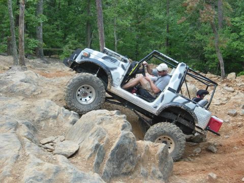 1995 Ford Bronco - An off-road vehicle navigates a challenging rocky trail.