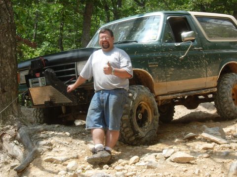 1995 Ford Bronco - A man poses with a lifted green 1995 Ford Bronco on a rocky trail.