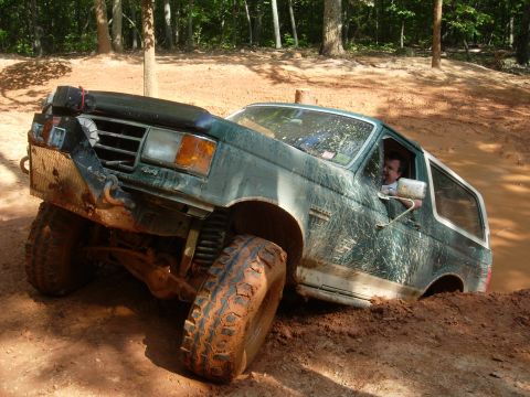 1995 Ford Bronco - This 1995 Ford Bronco is shown tackling a challenging muddy terrain during an off-road excursion.